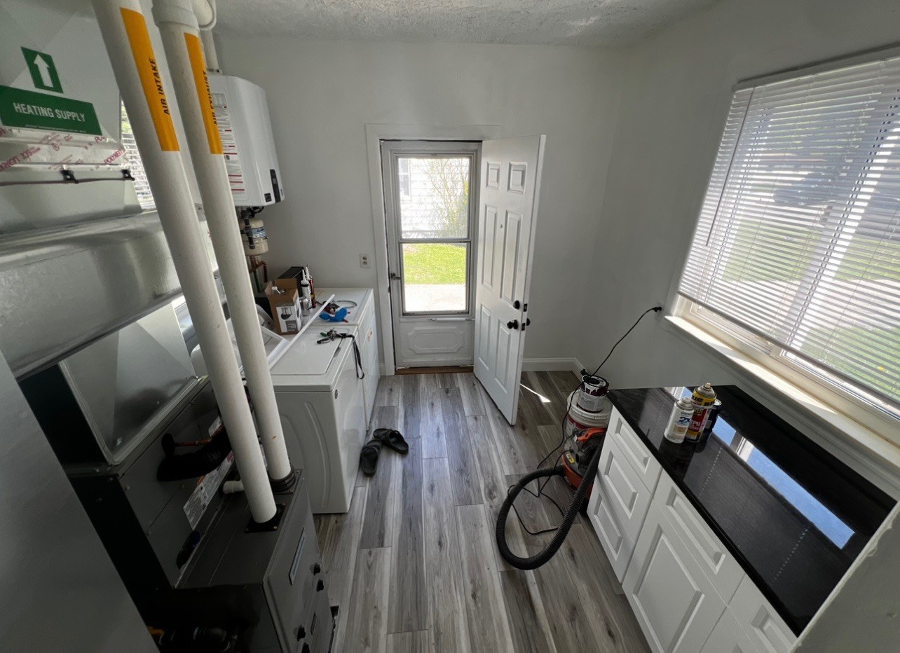 Updated utility room with new furnace after remodel