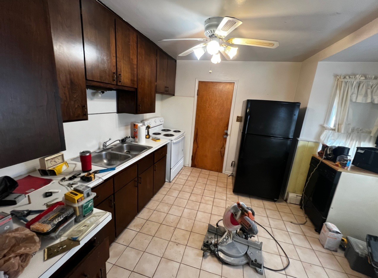 Dated kitchen with dark wood cabinets before remodel